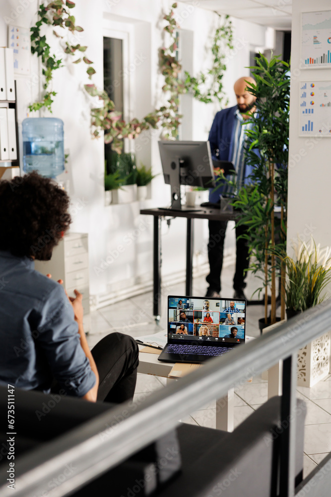 Wall mural executive manager discussing strategy with remote workers team on laptop screen while sitting in bus