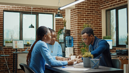 Furious man throwing files in boardroom, feeling stressed after team was failing to obtain new development plan. African america manager being angry and frustrated about office work results.