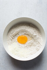 egg, Yeast and water placed in the middle of flour, process of making bread