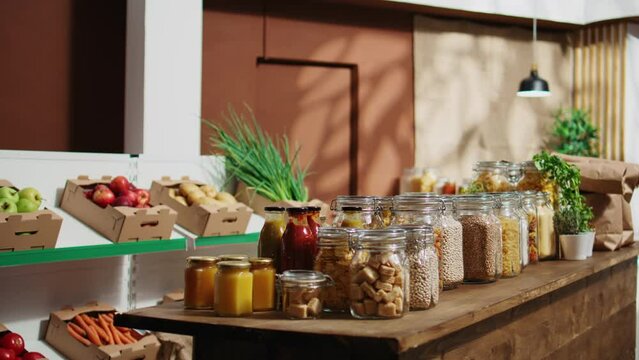 Dolly in shot of carbon neutral zero waste supermarket with fruits, vegetables, grains, spices and pasta on display. Empty low carbon footprint local neighborhood grocery store