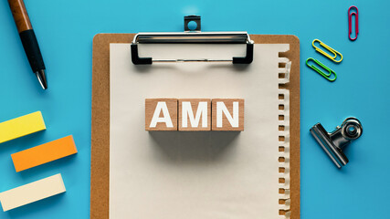 There is wood cube with the word AMN. It is an abbreviation for Artifical Mains Network as eye-catching image.