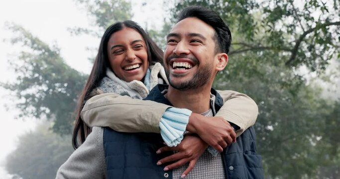 Love, couple and piggy back in the nature with a smile, happy date or people together for fun in the park, woods or walk in forest. Friends, Indian woman and man have quality time to play on vacation