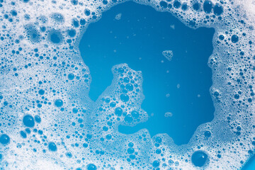 Detergent foam bubble on wate. Blue background, Soap sud