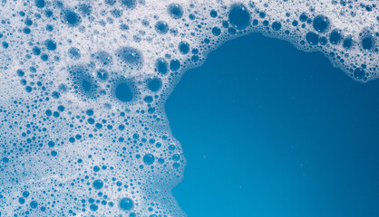 Detergent foam bubble on wate. Blue background, Soap sud