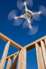 Drone Unmanned Aircraft System Flying to Inpect a House Wood Construction Framing Being Built.