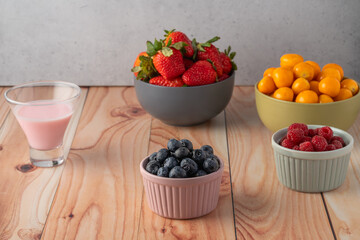 Strawberries, blueberries among other fruit and and yogurt