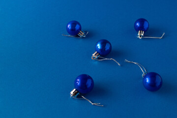 Christmas ornament balls on blue background. Blue aesthetic. Minimal holiday idea. Copy space.