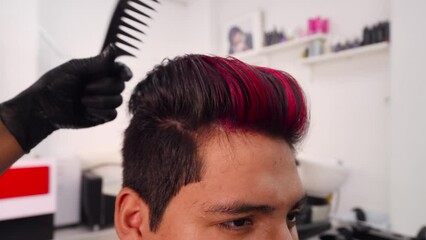 Professional hairdresser hairstyling customer's hair, combing his hair close-up.MOV