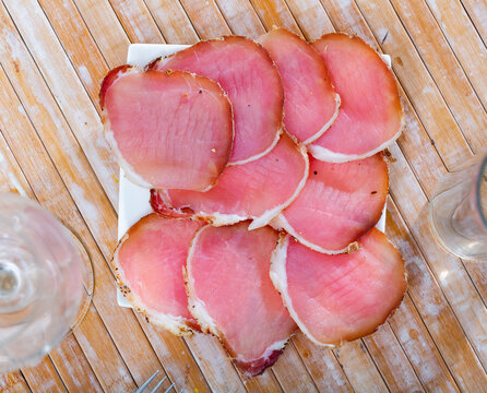 Sliced Polish cured sirloin pork polendvitsa served on plate. Traditional meat delicacies..