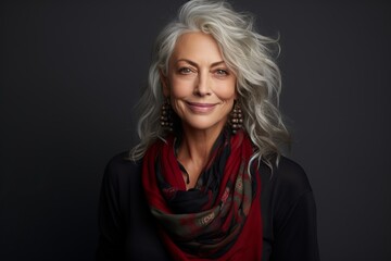 Portrait of a happy senior woman with gray hair and red scarf.