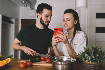 Caucasian couple in love using cellphone application for browsing wireless website connecting to 4g 