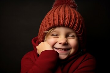 portrait of a little girl in a red hat on a dark background
