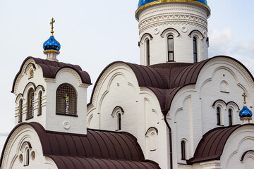 View of a stone Orthodox church with blue domes and gilded crosses. Village Krivskoye, Kaluga...