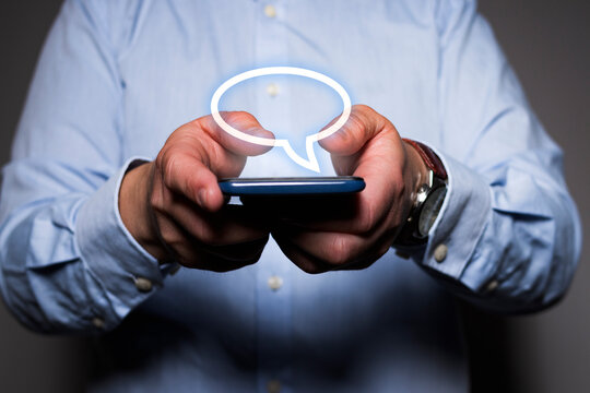 Unrecognizable man using chat app on a mobile