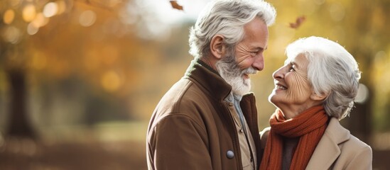 Obraz premium Elderly couple filled with joy deeply affectionate towards each other enjoying the outdoors of a park