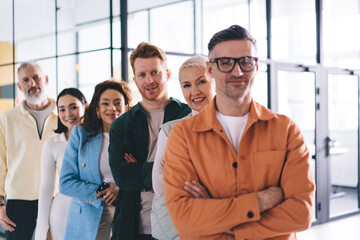 Obraz premium Half length portrait of Caucasian male proud CEO in optical eyewear for provide vision correction looking at camera during time for together briefing in office workspace, confident businessman