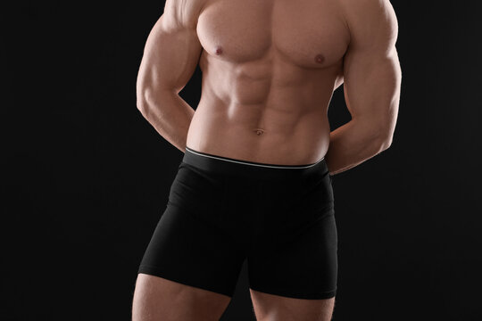 Young man in stylish underwear on black background, closeup