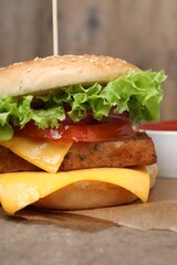 Delicious burger with tofu and fresh vegetables on table, closeup