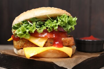 Delicious tofu burger served with sauce on board, closeup