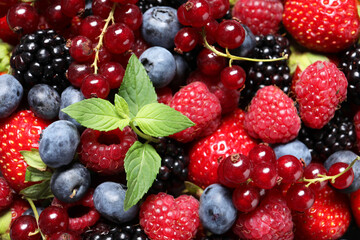 Many different fresh ripe berries as background, top view