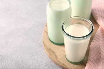 Glassware with tasty milk on table, closeup. Space for text