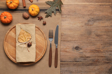 Stylish autumn table setting on wooden background, flat lay. Space for text