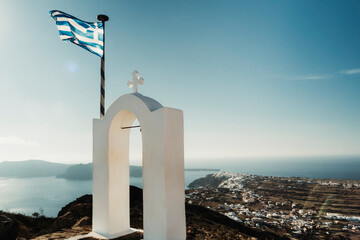 Greek flag and with Oia city in the back - obrazy, fototapety, plakaty