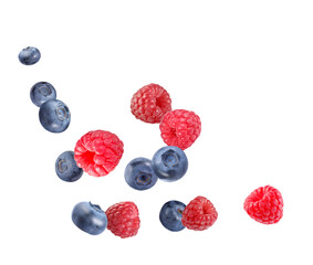 Fresh ripe blueberries and raspberries falling on white background
