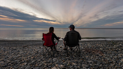 My wife and I chatting in front of our campsite at Agate Beach on Haida Gwaii, British Columbia,...