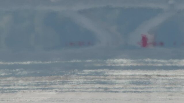 Close-up of Airplane Wheels Touching Down on Runway