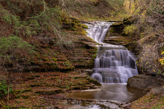 Afternoon fall, autumn photo of a waterfall in Robert H. Treman State Park near Ithaca NY, Tompkins County New York.	
