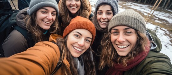 A photo taken by a group of joyful friends during their camping trip captures their bond and diverse backgrounds With smiles on their faces they capture the beautiful scenery and the women e