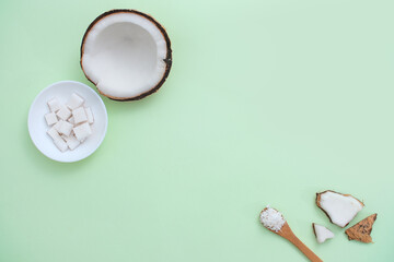 White ceramic plate holds diced coconut, complemented by fresh coconuts and props. A visual representation simulating the research and development of innovative products from tropical fruits.