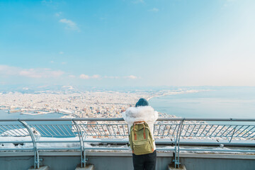 Woman tourist Visiting in Hakodate, Traveler in Sweater sightseeing view from Hakodate mountain...