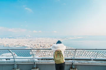 Photo sur Plexiglas Pool Woman tourist Visiting in Hakodate, Traveler in Sweater sightseeing view from Hakodate mountain with Snow in winter. landmark and popular for attractions in Hokkaido, Japan.Travel and Vacation concept