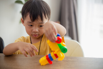 Cute little boy playing with colorful toys