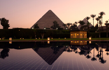 Great Pyramid of Giza at sunset with water pool reflection