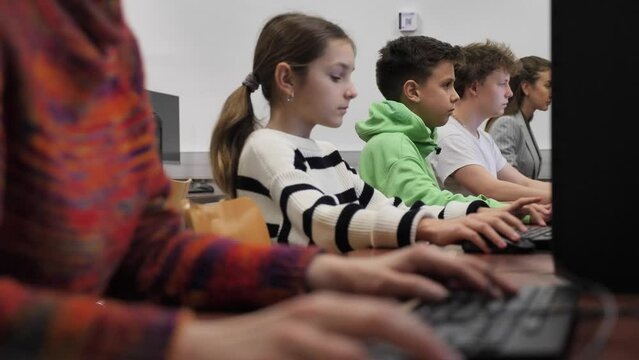 Schoolgirl using computer during computer sciene lesson in school.