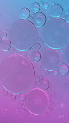 Abstract background. Oil water. Bubbles texture. Round stains spots floating on neon purple shimmering particles fluid surface in hypnotic art.