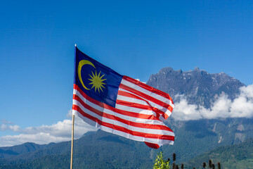 Flag of Malaysia with Mount Kinabalu in the Background