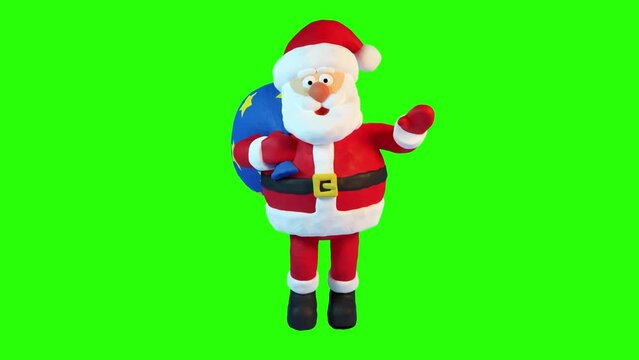 Santa with a bag walks and waves his hand. Cartoon Santa Claus. Front view Animation with plasticine stop motion effect. Alpha channel.
