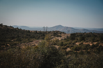 Landscape view of telephone poles through dry desert hillsides near Prescott Arizona in Granite Mountains