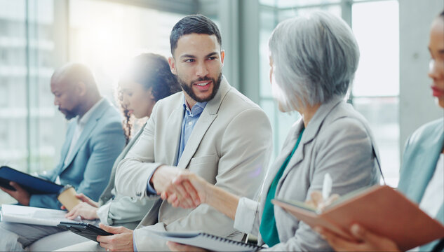 Business people, handshake and meeting in seminar greeting, introduction or teamwork at office. Businessman shaking hands with woman in staff training, team workshop or recruiting deal at workplace