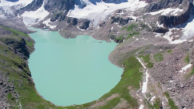Slow aerial drone shot of Chitta Katha Lake in the Himalayan mountain range.