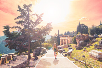 Woman tourist visiting famous touristic site of Delphi in Greece
