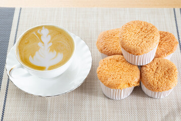 Homemade sponge cake or chiffon with coffee tea cup white plate, soft, delicious ingredients: eggs, flour, milk, vanila. Bakery pie cupcake concept, background wallpaper. Muffin coffee break set.