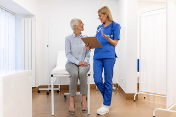 Portrait of female doctor explaining diagnosis to her patient. Female Doctor Meeting With Patient In Exam Room. Shot of a medical practitioner reassuring a patient