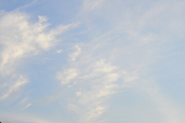 Fototapeta premium The bright blue sky is obscured by a haze of light clouds