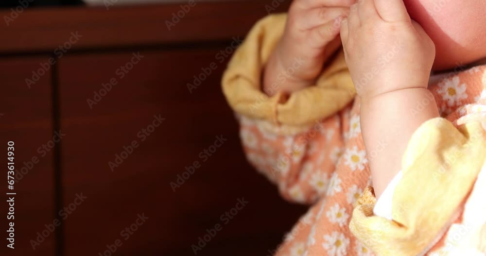 Wall mural A 2x slow motion of child's hands in the living room closeup handheld