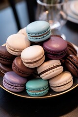 A stack of assorted macarons on a platter, traditional French dessert cookies, food photography